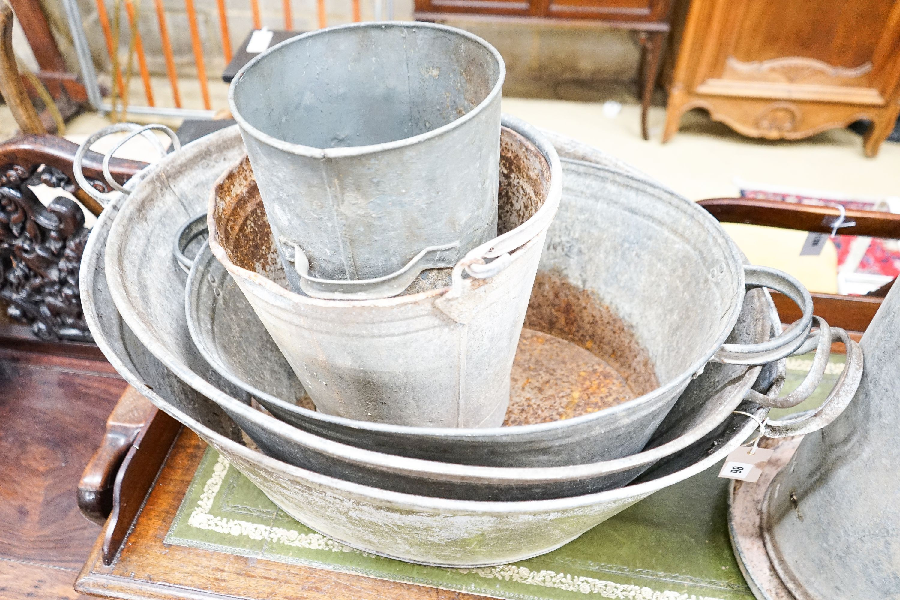 Five galvanised containers and a chicken feeder, largest 84cm